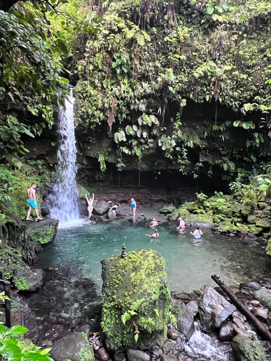 People jumping into Emerald Pool swimming hole