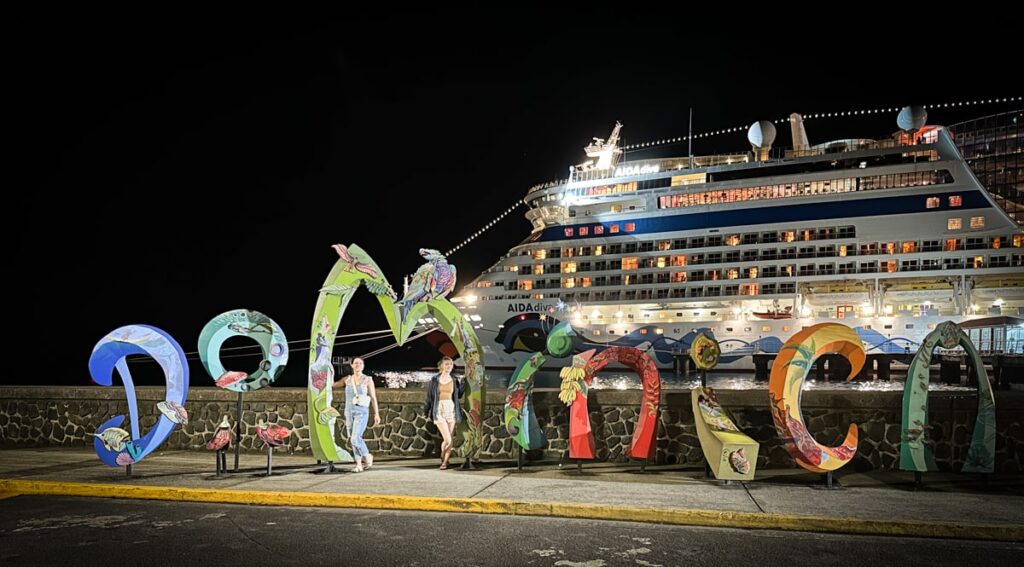 Dominica sign with cruise ship in background 