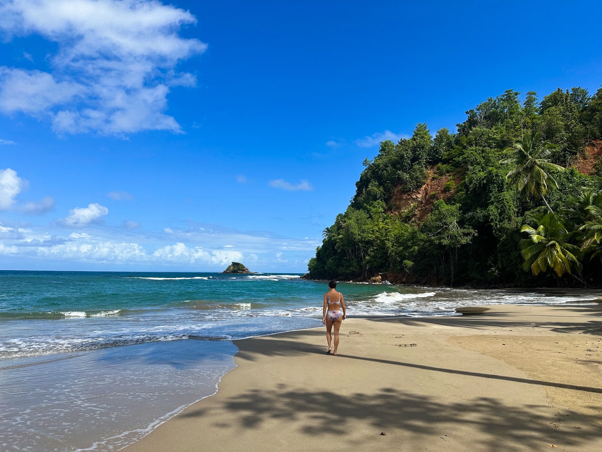 woman walking along the beach in Northern Dominica on Batibou Beach
