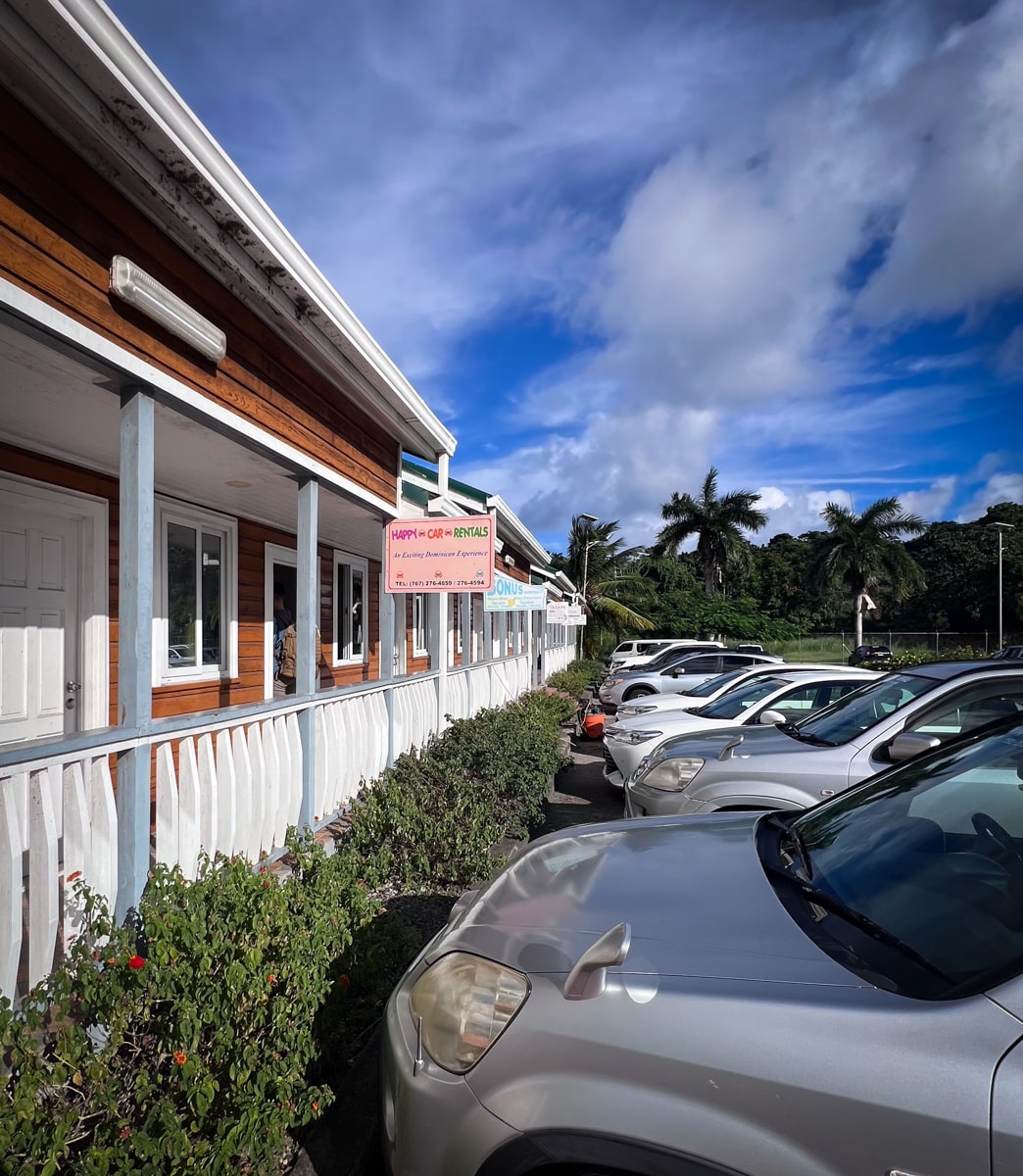 Happy Car Rentals location with cars in Dominica