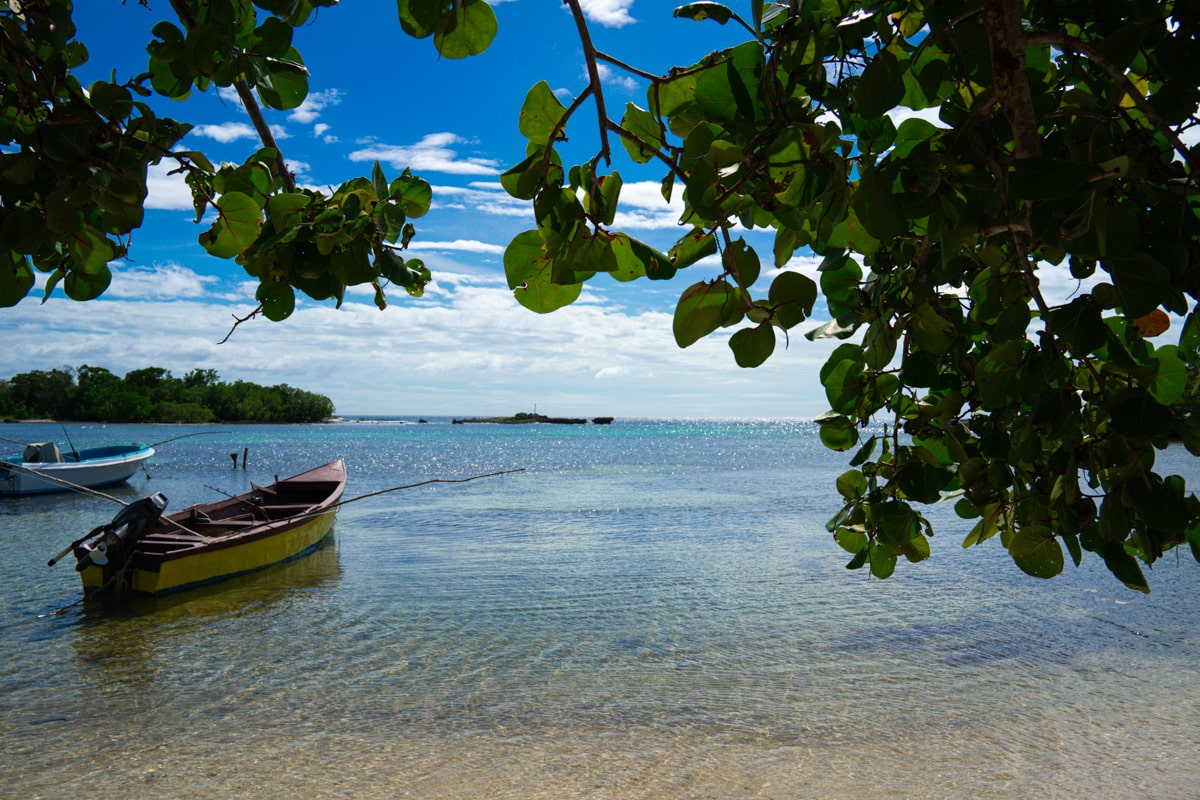 off-the-beaten-path beach in Jamaica with a boat and blue water