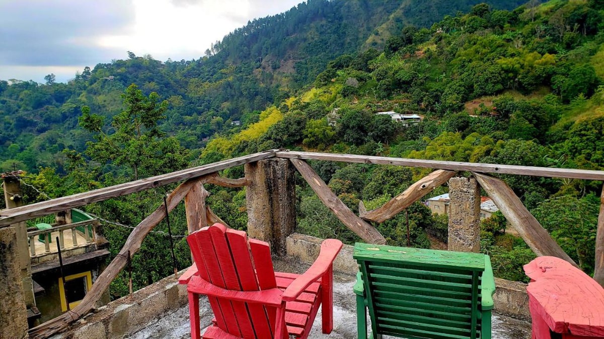 two colorful patio chairs overlooking the blue mountains from Prince Valley Guesthouse 