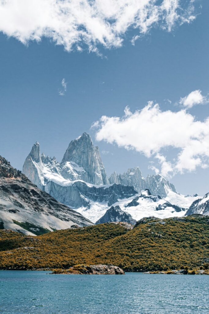 view of snow capped mountains in Argentina with a lake 