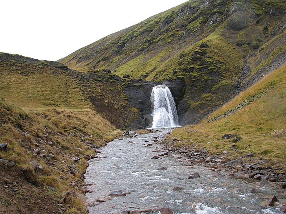 view of the Helgufoss waterfall in Iceland from down river. 