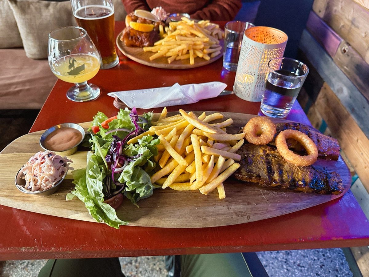 Lamb dinner with fries and a salad and dipping sauces