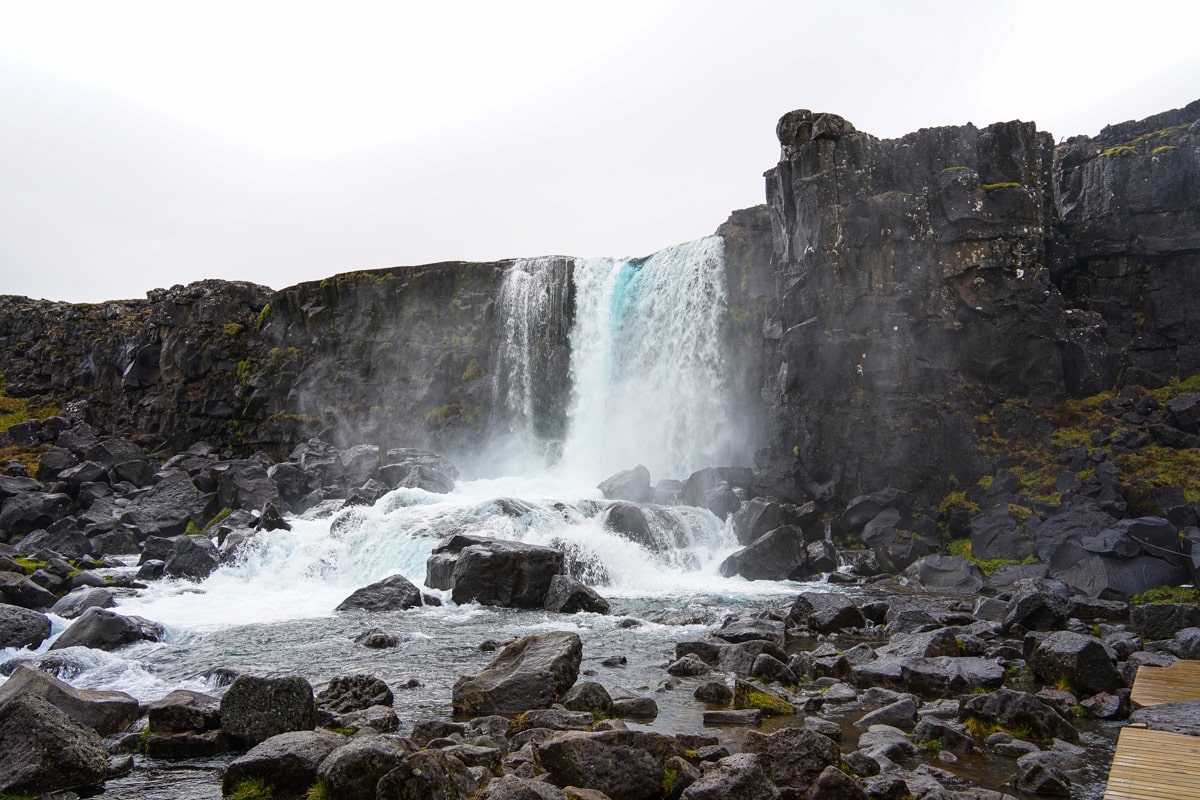 Oaxarafoss waterfall view from the viewing platform with blue hued water