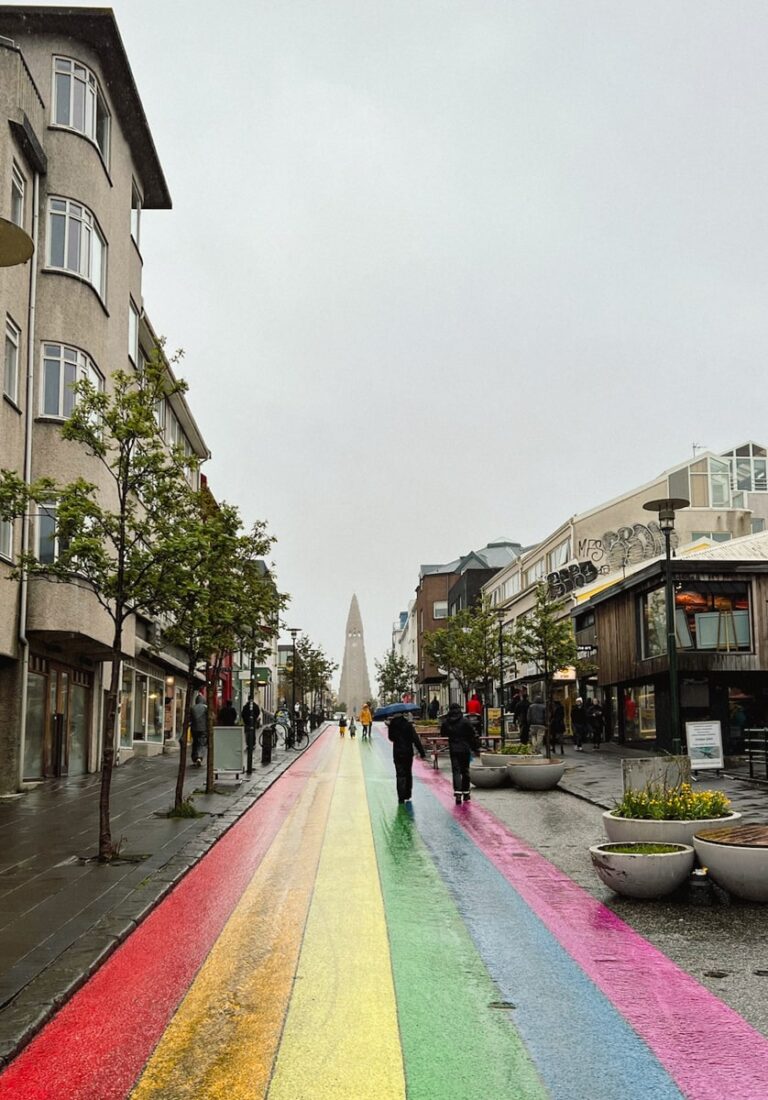people walking along the rainbow street in Reykjavik to the famous Hallgrímskirkja church