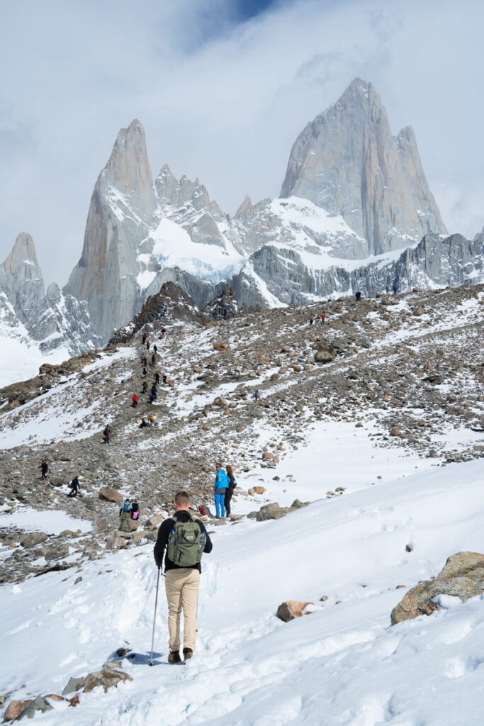 man hiking to Mount Fitz roy with snow on the ground