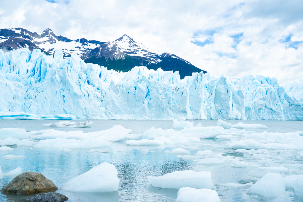 Perito Moreno Glacier with floating icebergs and mountains in the background