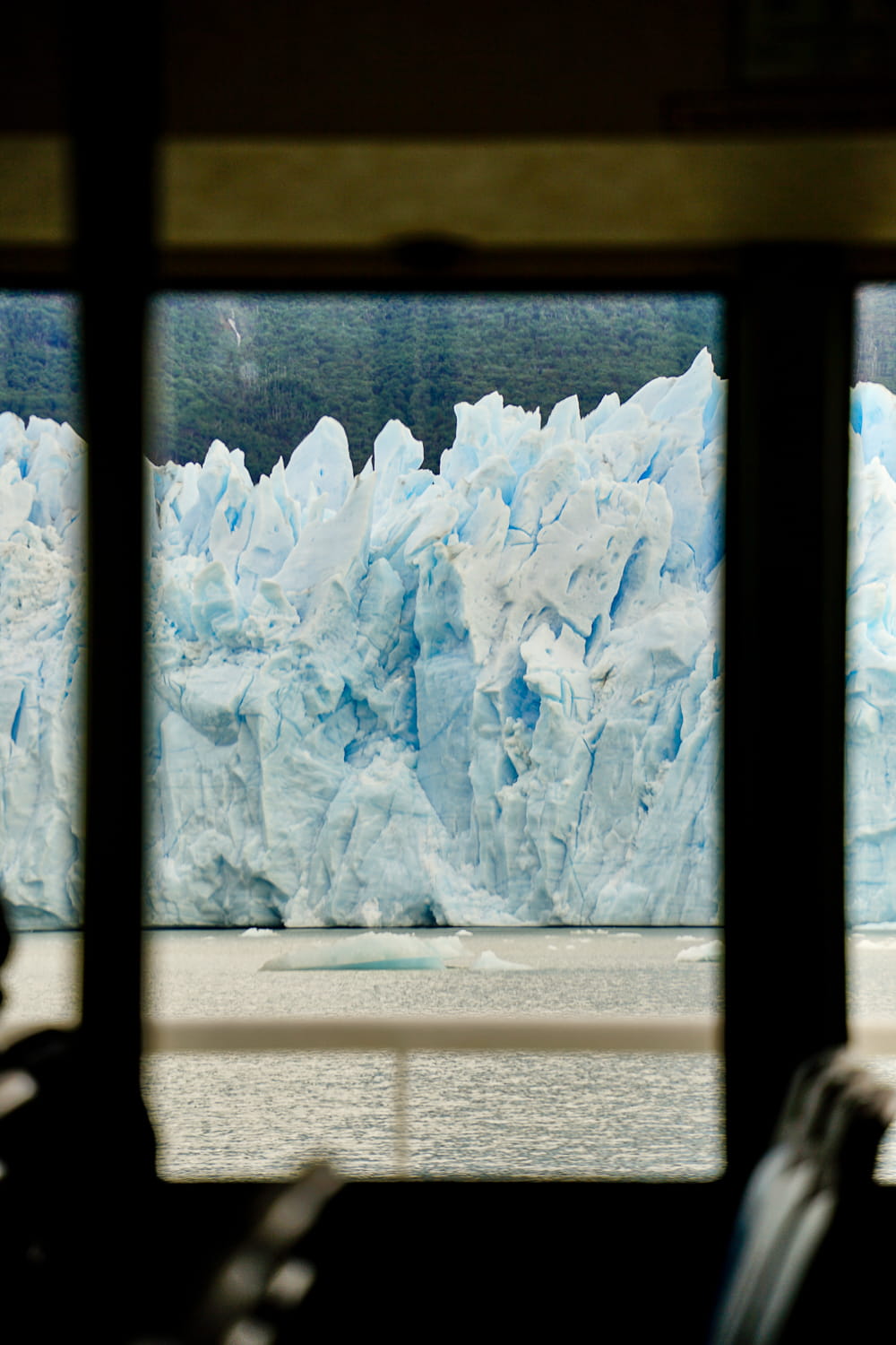 View of the Perito Moreno glacier ice through a window on the boat ferry
