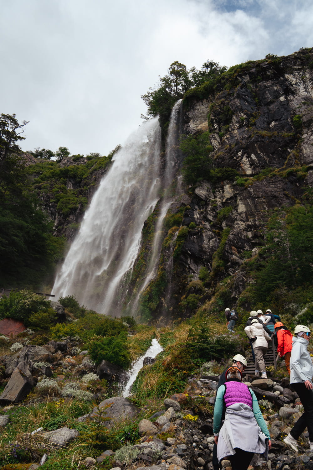 People walking up to the waterfall that overlooks Perito Moreno Glacier in El Calafate, Argentina